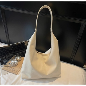 Minimalist cream tote bag in lychee texture leather with laptop and books for commuting