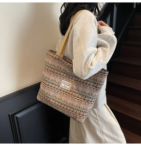 Detailed shot of ethnic geometric pattern tote bag with woven shoulder strap and label