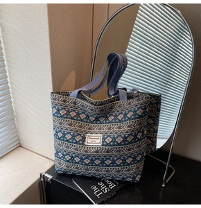 Detail of blue bohemian tote bag showing woven geometric patterns and durable handles