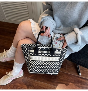 Detail of canvas tote bag with black and white geometric ethnic patterns and fabric handles
