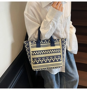 Detail of navy and white geometric pattern tote bag with bohemian woven textures