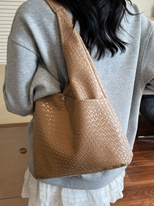 Brown woven leather hobo shoulder bag with a large capacity for daily commuting