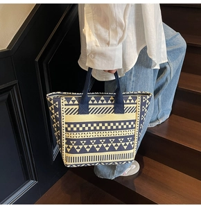 Lifestyle shot of a canvas tote bag with bohemian geometric patterns on stairs