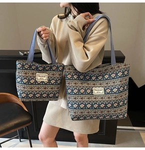 Ethnic style tote bags in two sizes featuring dark blue woven patterns with orange accents