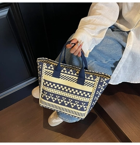 Close-up of geometric pattern canvas tote bag with sturdy blue strap handles and spacious design