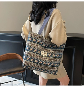 Rear view of model carrying a bohemian canvas tote bag with colorful geometric patterns
