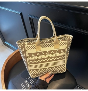 Close-up of ethnic geometric pattern canvas tote bag with brown and beige print details