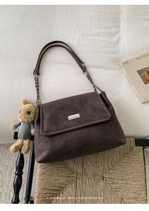 Retro dark brown tie-dye shoulder bag featuring chain strap and plush cat charm