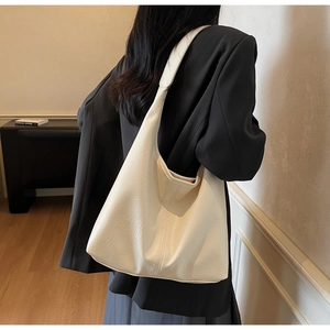 Close-up of cream-colored large tote bag with lychee texture and soft PU leather finish