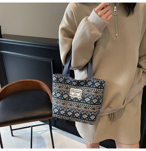 Detailed shot of ethnic print canvas tote bag with blue tribal pattern and woven handle