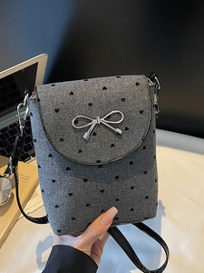 Grey heart pattern crossbody bag with silver bow buckle and leather strap