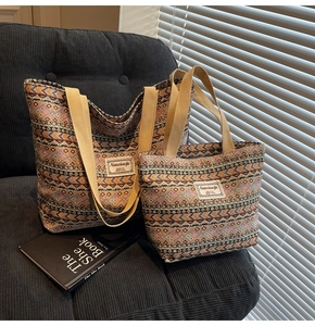 Detail of vintage ethnic woven tote bags in large and small sizes on a velvet sofa