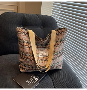 Close-up of ethnic geometric pattern tapestry tote with khaki canvas handles and logo