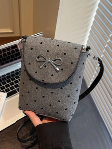 Mini crossbody phone bag with grey heart pattern fabric and silver bow accent