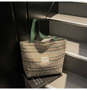 Close-up of geometric pattern canvas tote bag on stairs with woven texture detail