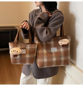 Detail of brown plaid tote bag set including large shoulder bag and small handbag