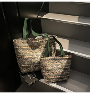Close-up of ethnic style woven tote bags with geometric patterns and green handles
