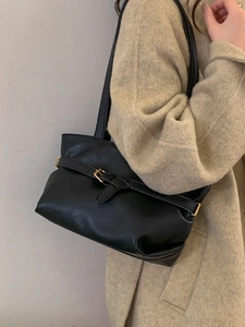 Chic black underarm bag with gold buckle strap for women in a stylish retro minimalist look