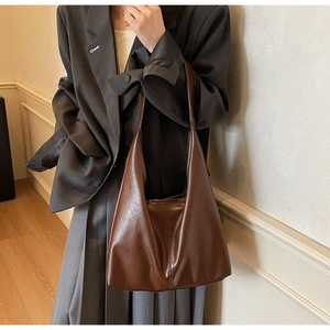 Detail of soft brown leather tote bag with minimalist large capacity hobo design