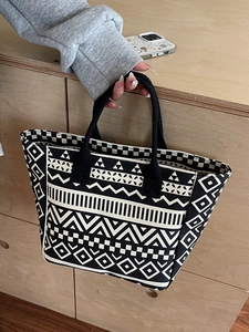 Black and white geometric canvas tote bag with bohemian ethnic patterns and woven handles