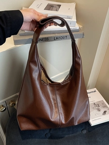 Minimalist large brown leather tote bag for women showing spacious commuter style capacity
