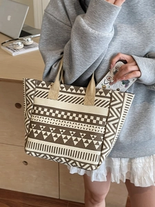 Canvas tote bag with vintage geometric patterns shown in a casual lifestyle setting
