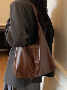 Minimalist vintage dark brown tote bag with saddle base and wide shoulder strap