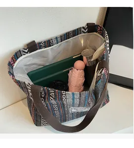 Interior view of large ethnic tote bag showing storage for tablet, umbrella and bottle