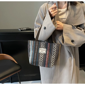 Detailed close-up of ethnic tote bag featuring geometric patterns and woven texture