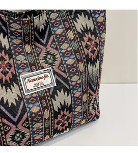 Close-up of bohemian geometric knit pattern and textured fabric on ethnic tote bag