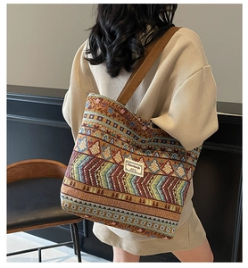 Detail showing vintage geometric woven fabric and wide shoulder strap on tote bag