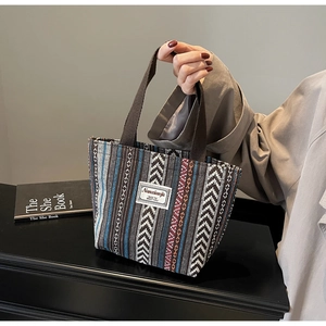 Detailed macro view of ethnic geometric weave pattern on a portable tote bag