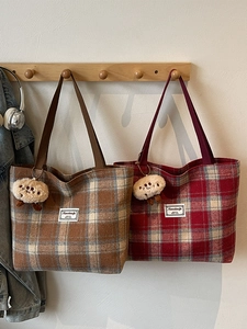 Retro plaid tote bags in coffee and burgundy with cute plush pendants on wooden hooks