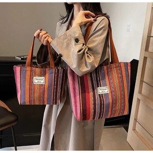 Detailed comparison of large and small ethnic striped tote bags with woven labels