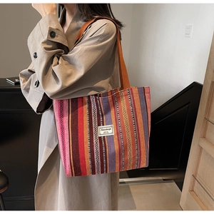 Close-up of ethnic striped tote bag showing woven texture and colorful geometric patterns