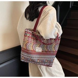 Close-up of bohemian woven tote bag with intricate geometric patterns and sturdy handles
