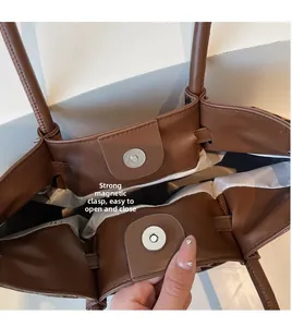 Detail of large brown tote bag with leopard print and strong magnetic buckle closure