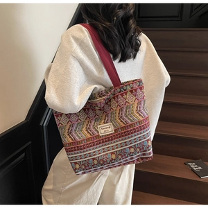 Detail of colorful ethnic embroidery and woven texture on a large capacity tote bag