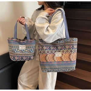 Ethnic canvas tote bags in large and small sizes with geometric patterns shown on stairs