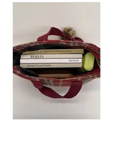 Macro view of large capacity red plaid tweed tote bag interior with dark lining