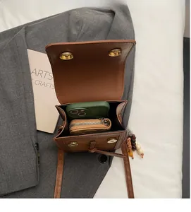 Internal view of brown leather crossbody bag showing capacity for phone and wallet
