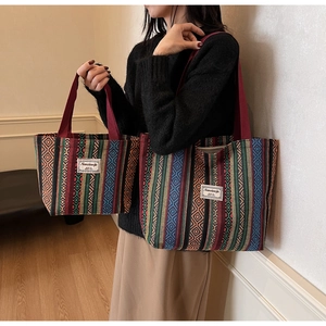 Detail view of large and small ethnic striped tote bags with bohemian patterns and handles