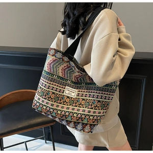 Detailed macro view of woven tote bag showing ethnic textures and striped patterns