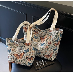 Close-up of floral jacquard tote bags with butterfly embroidery in two different sizes