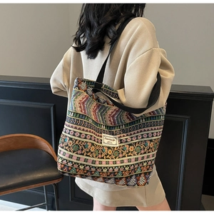 Detailed close-up of a large ethnic tote bag featuring vibrant woven geometric patterns