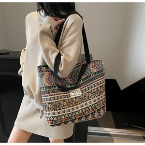 Close-up of geometric jacquard ethnic pattern and brand label on large tote bag