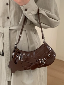 Chic dark brown faux leather underarm bag with metal grommets and floral charm detail