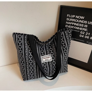 Close-up of the black and white ethnic pattern canvas tote with a minimalist fabric label