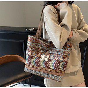 Close-up of geometric ethnic canvas weave and brand label on large tote bag