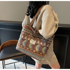 Detail of bohemian tote bag featuring intricate ethnic patterns and woven shoulder strap